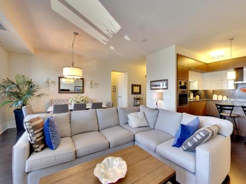 a living room with a white couch and blue pillows at View CN Tower and Lake from the Sky! in Toronto