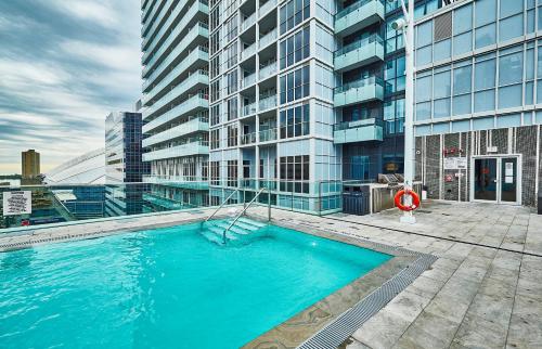 a large swimming pool on top of a building at View CN Tower and Lake from the Sky! in Toronto