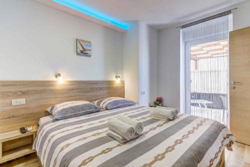 a bedroom with a large bed with a wooden headboard at Holiday home in Novi Vinodolski 45274 in Novi Vinodolski