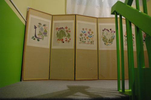 a room with four lockers with flowers on the walls at Oyama Guesthouse Kyoto in Kyoto