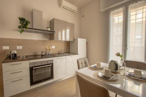 a kitchen with a table with chairs and a counter top at Mias flat in Scandicci
