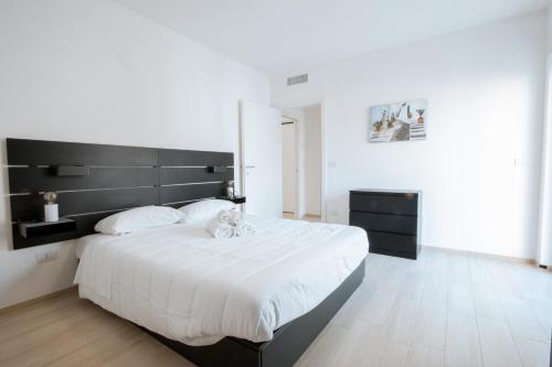a bedroom with a large bed with a black headboard at The Moon in Monopoli