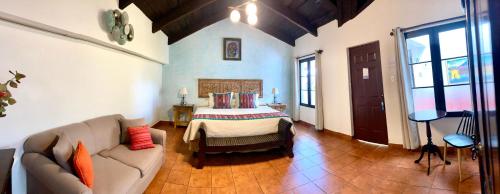 a living room with a couch and a bed at Hotel la Galería in Antigua Guatemala