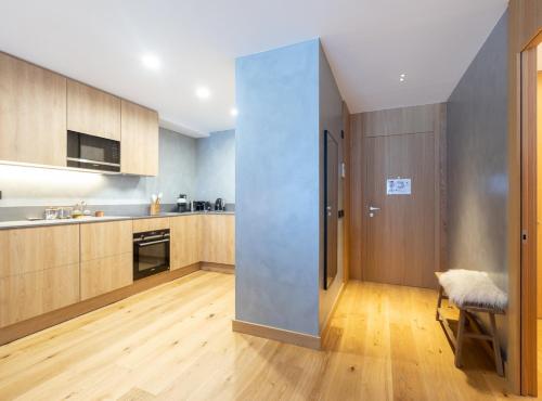 a kitchen with a large pivot door in the middle at ISARD HOMES & SPA by SELECT RENTALS in El Tarter