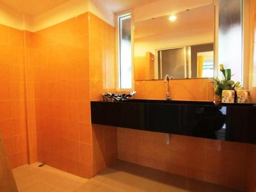 a bathroom with a sink and a mirror at Aurora Resort Kanchanaburi in Kanchanaburi