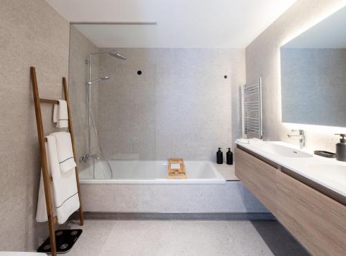 a bathroom with a tub and a sink and a shower at ISARD HOMES & SPA by SELECT RENTALS in El Tarter