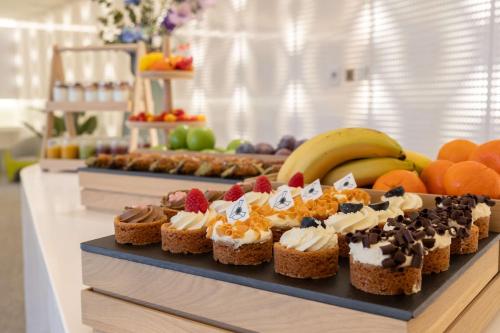 a tray of desserts on a table with fruit at Park Inn by Radisson Amsterdam City West in Amsterdam