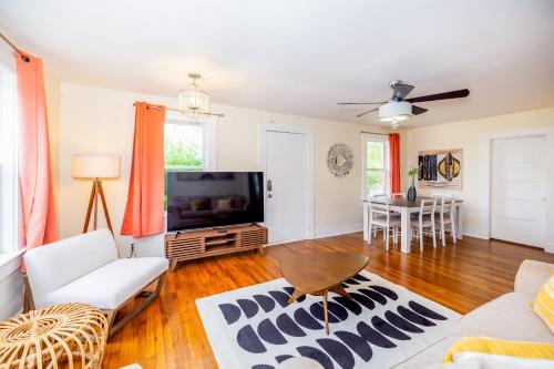 a living room with a couch and a tv at Lovely Home Away From Home - Entire House! in Austin