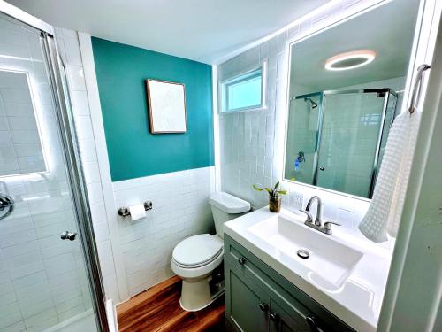 a bathroom with a toilet and a sink and a mirror at Lovely Home Away From Home - Entire House! in Austin