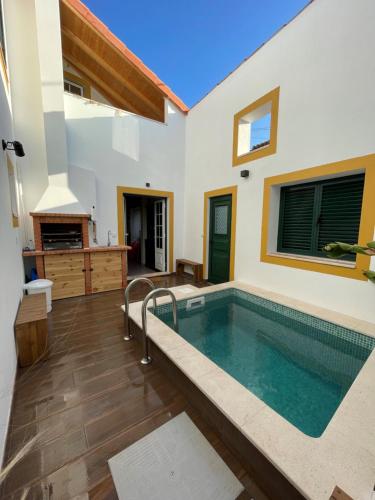 a swimming pool in the middle of a house at Casa Valada My Land in Valada