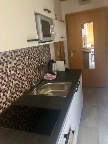 a kitchen with a sink and a counter top at Apartment "Birgit" Sonnleitn/Nassfeld in Sonnenalpe Nassfeld