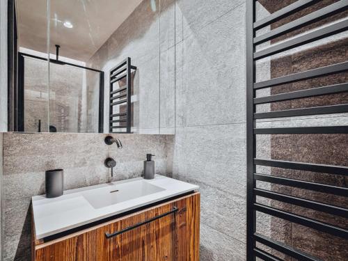 a bathroom with a sink and a shower at Duplex moderne au Casset pour 8 pers avec cheminée et balcon - FR-1-808-10 in Le Monêtier-les-Bains