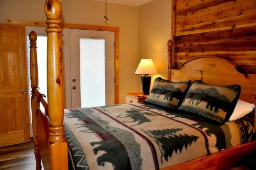 a bedroom with a bed with a wooden headboard at Little Heaven in Young Harris