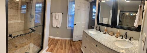 a bathroom with two sinks and a glass shower at Chatuge Fish Retreat in Hiawassee