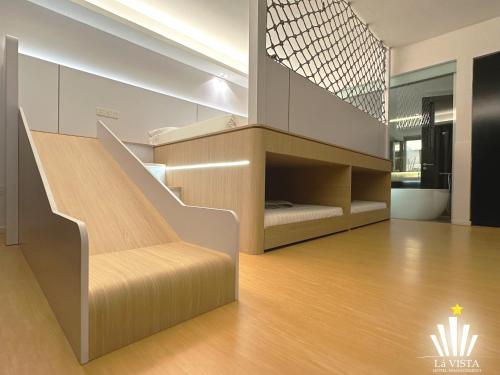 a room with stairs and a bed in it at The Shore Hotel & Residences By Lá VISTA in Melaka