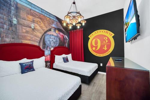 a room with two beds and a wall with a sign at EPIC 12 Bedroom Home with Private Pool in Kissimmee