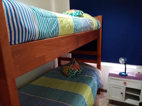 a bunk bed with a pillow on the bottom bunk at Casa Tunquen VIP in Tunquen