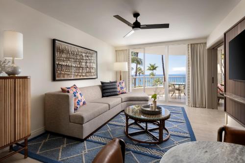 a living room with a couch and a table at Fairmont Kea Lani, Maui in Wailea