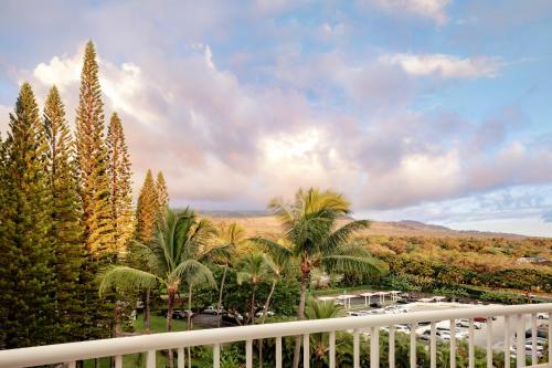 a view from a balcony of a resort with palm trees at Fairmont Kea Lani, Maui in Wailea