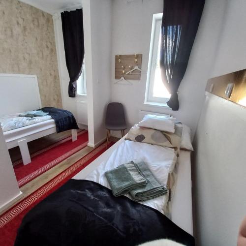 a small room with two beds and a window at Gavriel Boutique Residence Wellness Spa in Szada