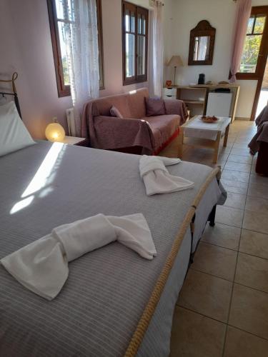 a bedroom with a bed and a living room at Anta's bnb in Ambelókipoi