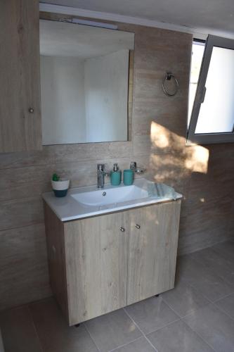 a bathroom with a sink and a mirror at Ioannis Home at Skonizo in Chania Town