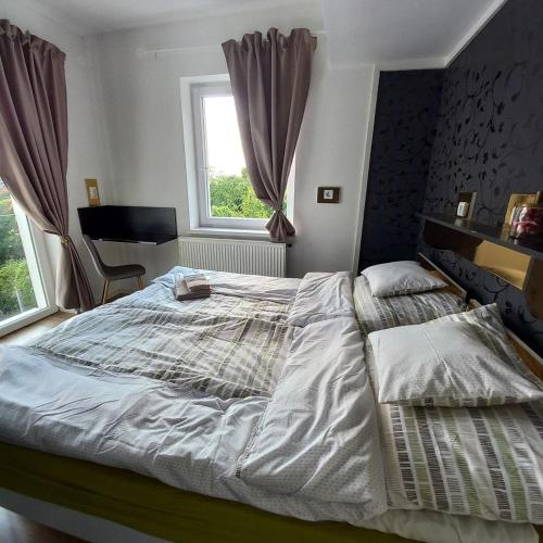 a bedroom with a large bed and a window at Gavriel Boutique Residence Wellness Spa in Szada