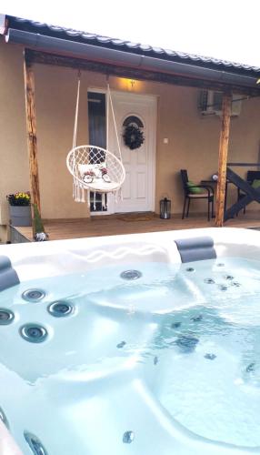 a jacuzzi tub in the backyard of a house at Panoráma Vendégház in Tahitótfalu