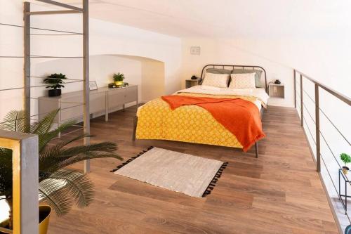a bedroom with a bed with an orange blanket at Bolero2 apartman in Budapest