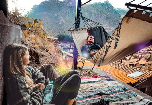 a man and a woman sitting in a hammock at Wolf Totem Lux Backpacker Industrial Studio in Pisac