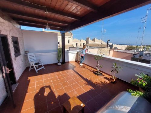 a person standing on the balcony of a house at Tina's House in Barletta