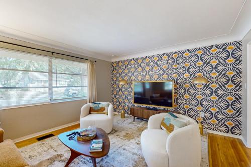 a living room with two chairs and a flat screen tv at Mount Dorable in Mount Dora