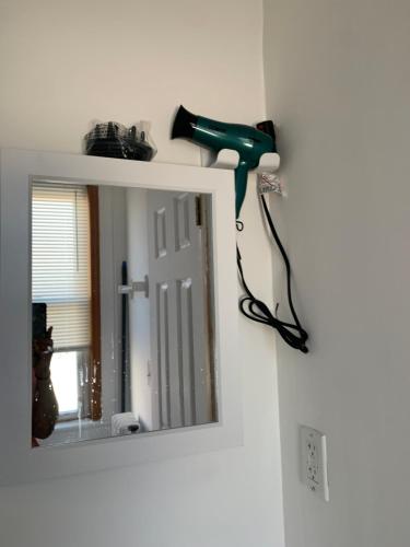a blow dryer on a wall next to a mirror at 2265 Bruckner Blvd Apartments in Bronx