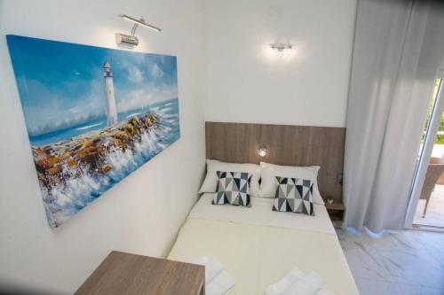 a bedroom with two beds and a painting on the wall at Apartments Sun Dance 2 with heated Pool in Novalja