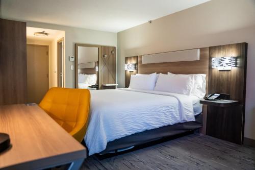 a hotel room with a large bed and a desk at Holiday Inn Express Frazer - Malvern by IHG in Frazer