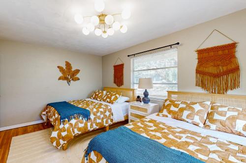 a bedroom with two beds and a chandelier at Mount Dorable in Mount Dora