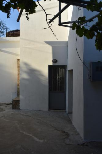 a white building with a door and a window at Ioannis Home at Skonizo in Chania Town