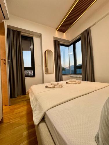 a bedroom with a bed with two towels on it at Maria Luxury Apartment in Skopje