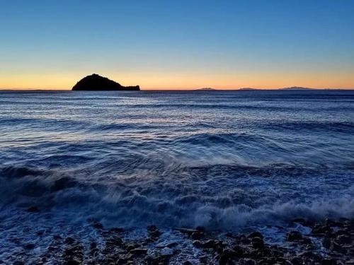 a body of water with a small island in the distance at LargoDoria - ViaArchivolto, box auto privato incluso in Albenga