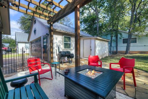 a patio with a table and chairs and a fire pit at Peach Street Retreat - Fire Pit and Close to Main St in Fredericksburg