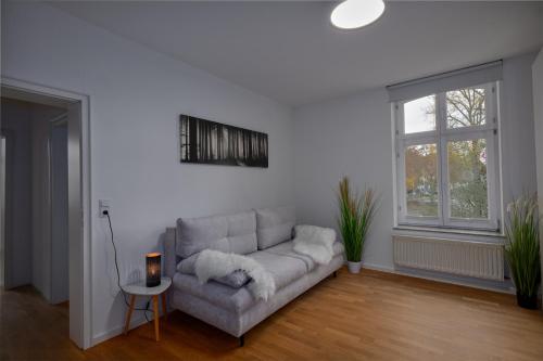 a white living room with a couch and a window at Soesthaus in Soest