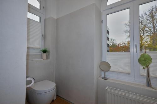 a bathroom with a toilet and a window at Soesthaus in Soest