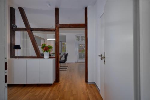 a hallway with a wooden floor and a room with a window at Soesthaus in Soest