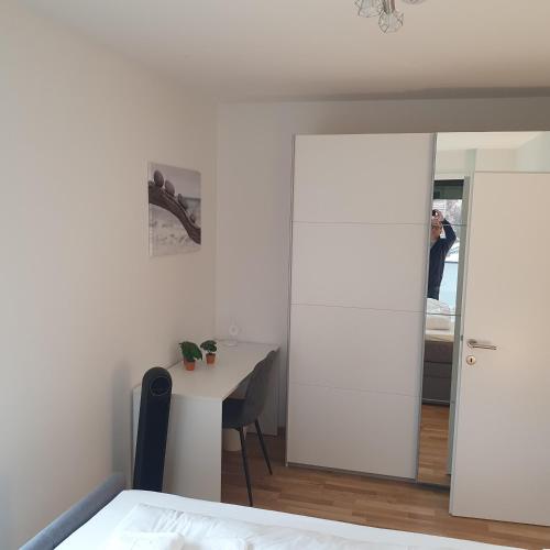 a bedroom with a table and a mirror at Primelweg Apartments in Graz