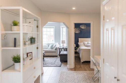 a room with a living room with a couch and a mirror at Your Halifornian Home Trendy 3 Bedroom Flat in Halifax
