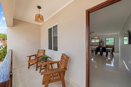 a living room with chairs and a dining room at Curadise Living in Willemstad