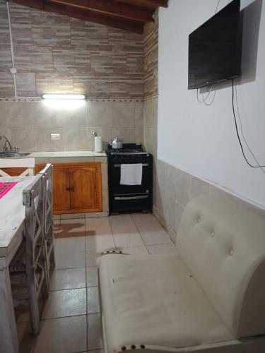 a kitchen with a tub and a stove in it at Mardifiore 1 ORO in General Madariaga