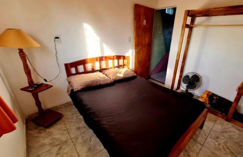 a bedroom with a large bed in a room at Estadía temporal in Quebrada de los Códores