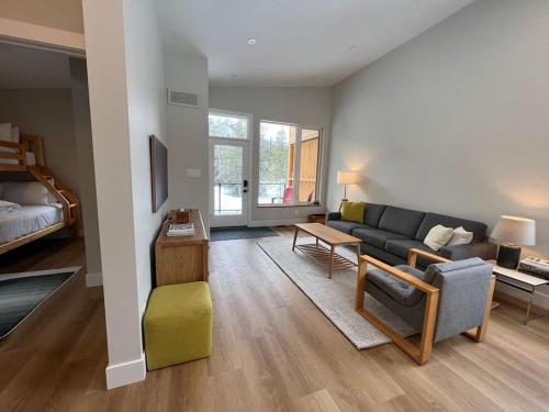 a living room with a couch and a table at 4595 Alpine Way by StayIn in Fernie