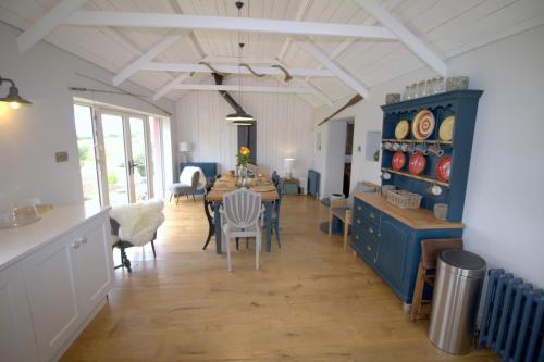 a kitchen and dining room with a table and chairs at The Oyster House in Dungloe